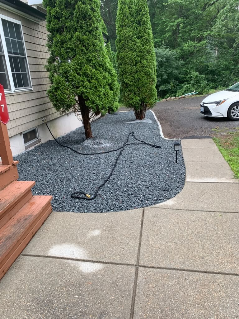 Backyard with fresh mulch beds and green lawn