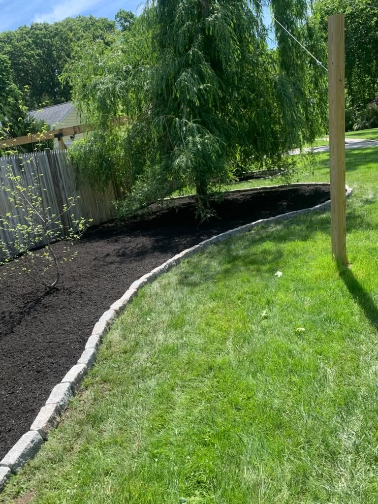 Backyard paver patio with landscaping
