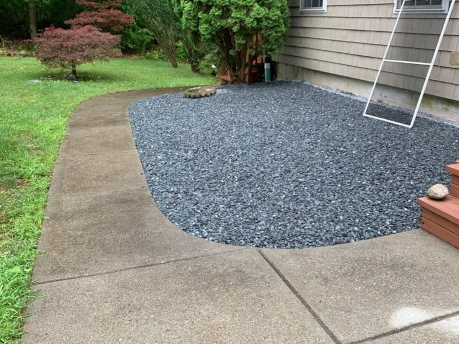Spring yard cleanup with rake and fresh planting beds
